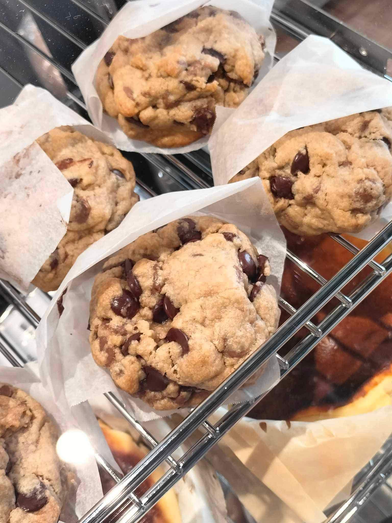 Chocolate chip cookies wrapped in paper inside the pastry case